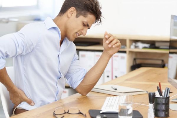 Male at desk with back pain
