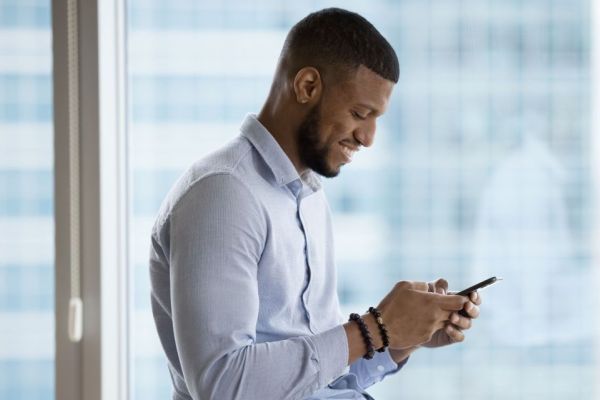 Banish the neck hump: exercises to improve pain and posture Man with head facing down while texting
