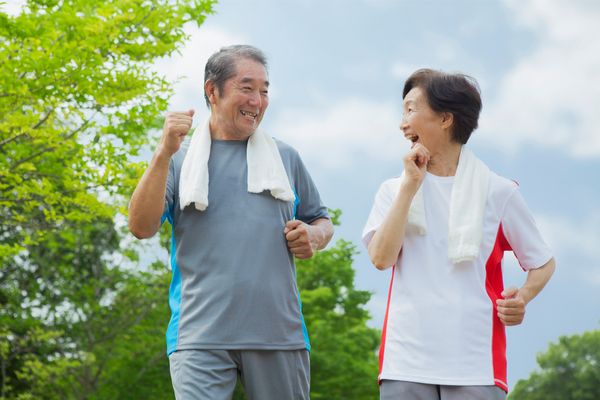 an elderly couple having a brisk walk outdoors