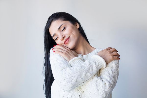A woman giving herself a hug
