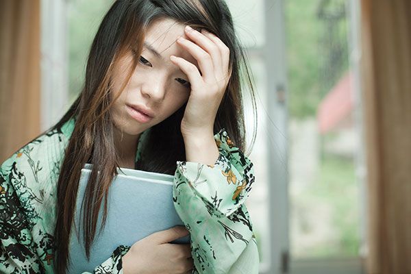 Girl with a concussion and hand on her head