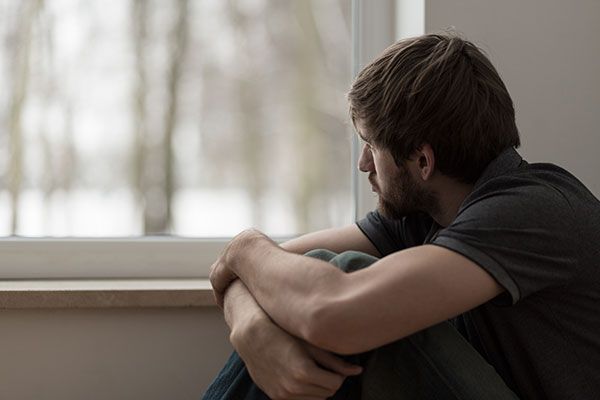 Man looking sad at a window